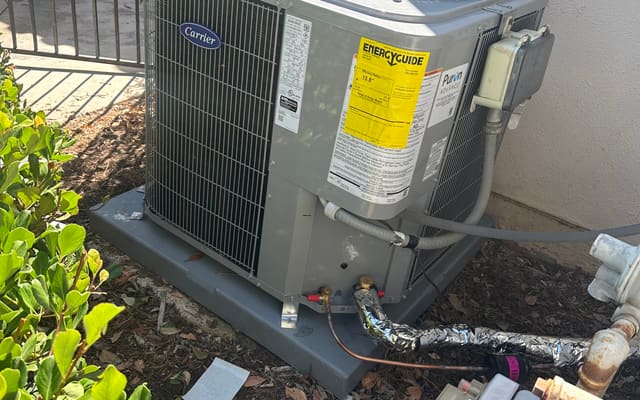 Newly installed Carrier condenser with the EnergyGuide label still attached
