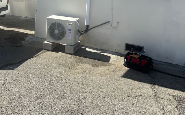 Ductless mini split outdoor unit with the line set run up the wall